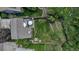 Overhead view of property features a manicured lawn, patio with seating, play set, and a fenced yard with mature trees for privacy at 573 Entrada Dr, Golden, CO 80401