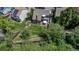 Aerial view of a well-maintained backyard with a patio, play area, lush green lawn, and mature trees providing shade and privacy at 573 Entrada Dr, Golden, CO 80401