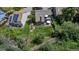Aerial view of a spacious backyard with lush lawn, patio seating, playground, and privacy fence, perfect for outdoor enjoyment at 573 Entrada Dr, Golden, CO 80401