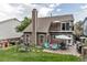 Exterior view of a two-story home with a private balcony, a patio, and a well-maintained lawn at 573 Entrada Dr, Golden, CO 80401