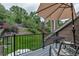 Charming deck with an umbrella and seating that overlooks a lush green backyard at 573 Entrada Dr, Golden, CO 80401