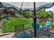 Charming backyard with stone terraces, grassy slopes, mature trees, and an inviting patio area for relaxation at 573 Entrada Dr, Golden, CO 80401