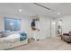Well-lit bedroom boasts a comfortable bed, egress window, and ample storage with a white dresser at 573 Entrada Dr, Golden, CO 80401