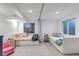 Bright basement bedroom featuring two built-in beds, egress windows, and fresh, white decor at 573 Entrada Dr, Golden, CO 80401