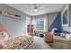Colorful ' bedroom includes a bed, shelving unit, pink chair and ample light at 573 Entrada Dr, Golden, CO 80401
