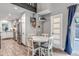 Bright dining area featuring a white table with seating for four and hardwood floors at 573 Entrada Dr, Golden, CO 80401