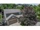 A close aerial view of a well maintained home with beautiful landscaping and attached garage at 573 Entrada Dr, Golden, CO 80401