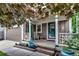 Inviting front porch featuring charming decor, lush landscaping, and a welcoming entrance to the home at 573 Entrada Dr, Golden, CO 80401
