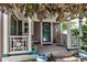 Charming front porch features white railings, rocking chairs, and a covered entry, perfect for relaxation at 573 Entrada Dr, Golden, CO 80401