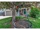 Relaxing tree swing in the front yard enhances the curb appeal of the inviting home exterior with a cozy porch and green lawn at 573 Entrada Dr, Golden, CO 80401