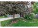 Exterior view of a well-maintained home with an inviting tree swing, landscaped lawn, and charming front porch at 573 Entrada Dr, Golden, CO 80401