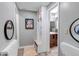 Inviting hallway featuring a convenient mudroom bench and access to a well-lit, updated bathroom at 573 Entrada Dr, Golden, CO 80401