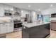 Modern kitchen featuring stainless steel appliances, white cabinets, and granite counters, seamlessly connected to the living area at 573 Entrada Dr, Golden, CO 80401