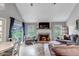 Inviting living room with fireplace, television, hardwood floors, and a seamless transition to the outdoor patio at 573 Entrada Dr, Golden, CO 80401