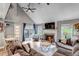 Spacious living room with a vaulted ceiling, fireplace, and sliding glass doors to the outdoor patio at 573 Entrada Dr, Golden, CO 80401