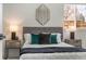 Well-lit bedroom featuring a soft bed with neutral bedding and matching end tables at 4043 E Geddes Cir, Centennial, CO 80122