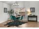 Dining area featuring a wood table, velvet green chairs, and a stylish chandelier at 4043 E Geddes Cir, Centennial, CO 80122