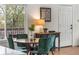 Dining area featuring a wood table, velvet green chairs, and a bright window at 4043 E Geddes Cir, Centennial, CO 80122