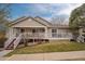 Well-maintained home with a large porch and manicured lawn, perfect for outdoor living at 4043 E Geddes Cir, Centennial, CO 80122