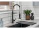 Modern kitchen sink with black faucet, white countertops, and subway tile backsplash at 4043 E Geddes Cir, Centennial, CO 80122