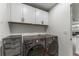 Functional laundry room with modern washer and dryer set and ample storage at 4043 E Geddes Cir, Centennial, CO 80122