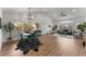 Open-concept living room with vaulted ceilings, wood floors, stylish furnishings, and large windows at 4043 E Geddes Cir, Centennial, CO 80122
