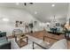 Bright living room with vaulted ceilings, wood floors, modern furnishings, and abundant natural light at 4043 E Geddes Cir, Centennial, CO 80122