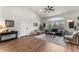 Cozy living room with wood floors, a modern sofa, stylish chairs, and a bright window at 4043 E Geddes Cir, Centennial, CO 80122