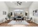 Bright living room with vaulted ceilings, wood floors, modern sofa, and large windows at 4043 E Geddes Cir, Centennial, CO 80122