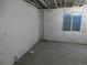Spacious unfinished basement with padded walls and a window letting in natural light; ready for renovation at 4482 S Ukraine Ct, Aurora, CO 80015