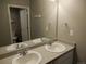Bathroom featuring double sinks, large mirror and tile floors at 4482 S Ukraine Ct, Aurora, CO 80015