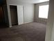 Bedroom with carpet, neutral walls, closet and one window at 4482 S Ukraine Ct, Aurora, CO 80015