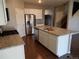 Bright kitchen features stainless steel appliances, granite countertops, and center island at 4482 S Ukraine Ct, Aurora, CO 80015