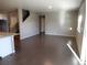 Open living room features dark wood floors, neutral walls, and staircase at 4482 S Ukraine Ct, Aurora, CO 80015