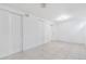 A spacious basement with white tile flooring and white paneled doors offers versatile living or storage space at 11976 E Arizona Dr, Aurora, CO 80012