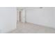 A well-lit basement features neutral tile flooring and a white door, offering potential for customization at 11976 E Arizona Dr, Aurora, CO 80012