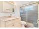 A well-lit bathroom showcases a single vanity with a marble countertop and a shower with glass door at 11976 E Arizona Dr, Aurora, CO 80012