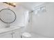 A bathroom featuring subway tile in the shower, a round mirror and a modern vanity at 11976 E Arizona Dr, Aurora, CO 80012