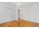 Bright bedroom features hardwood floors, a ceiling fan, and closet for ample storage at 11976 E Arizona Dr, Aurora, CO 80012