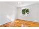 Bright bedroom features hardwood floors, a ceiling fan, and a window providing natural light and a pleasant view at 11976 E Arizona Dr, Aurora, CO 80012