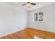 Bedroom featuring hardwood floors, white walls, ceiling fan and a window at 11976 E Arizona Dr, Aurora, CO 80012