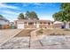 Charming single-story brick home featuring an attached garage, manicured lawn, and inviting front yard at 11976 E Arizona Dr, Aurora, CO 80012