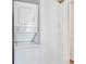 Compact laundry area features stacked white washer and dryer and white walls at 11976 E Arizona Dr, Aurora, CO 80012