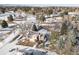 Aerial view of home with gray roof in snowy neighborhood at 6056 S Coventry E Ln, Littleton, CO 80123