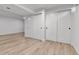 Basement features light wood flooring and large closet with sliding doors at 12801 Randolph Pl, Denver, CO 80239