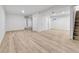 Spacious basement with light wood flooring, white walls, and ample lighting at 12801 Randolph Pl, Denver, CO 80239