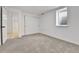Cozy bedroom with a neutral carpet, sliding closet doors, and ample natural light at 12801 Randolph Pl, Denver, CO 80239