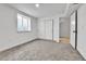 Bedroom boasts gray carpeting, closet with sliding doors, white trim, and a window at 12801 Randolph Pl, Denver, CO 80239