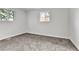 Bright bedroom with plush gray carpeting, fresh paint, and natural light from two windows at 12801 Randolph Pl, Denver, CO 80239