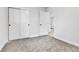 Cozy bedroom features neutral carpeting and a closet with sliding doors for optimal storage at 12801 Randolph Pl, Denver, CO 80239